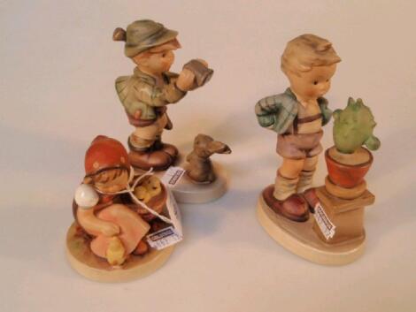 Goebel figures, girl with chicks, boy with cactus, boy with gun and rabbit