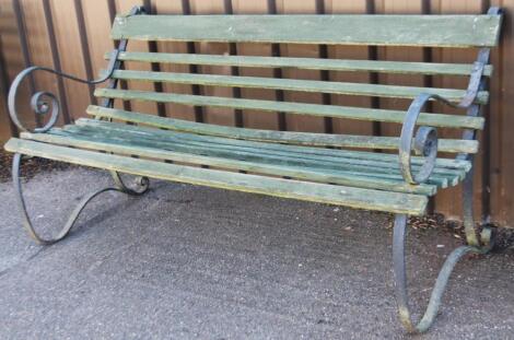 An early 20thC wrought iron and slatted wooden railway or garden bench