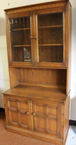 An Ercol dark wood display cabinet