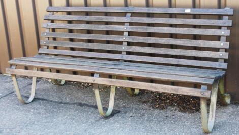 A 20thC wrought iron and slatted wooden railway or garden bench