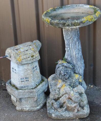 A modern garden statue windmill ornament and a bird bath