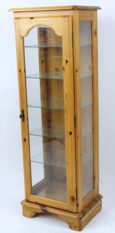 A Corndell stripped and lightly polished pine display cabinet