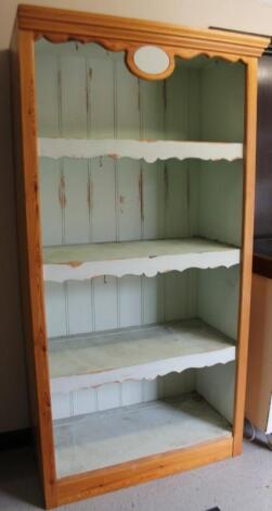 A stripped and lightly polished pine open cabinet