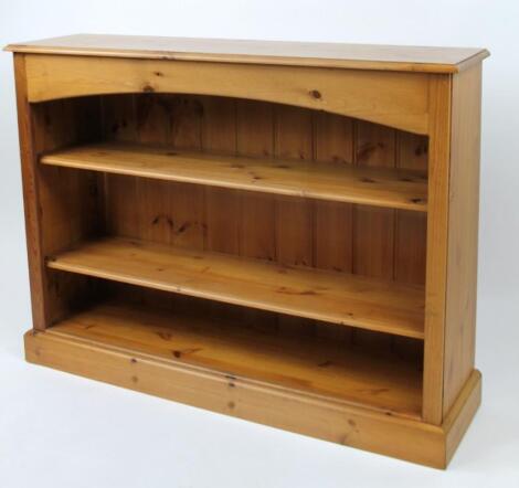 A stripped and lightly polished pine freestanding bookcase