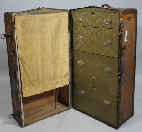 An early 20thC metal bound travel wardrobe trunk