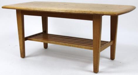 A mid 20thC Ercol style light elm finished coffee table