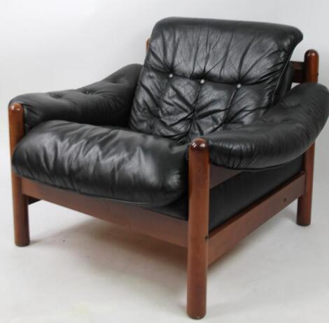 A mid 20thC black leather and wooden framed Eames style chair