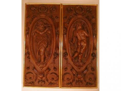 A pair of 19thC carved oak panels depicting cherubs with a wheat sheaf