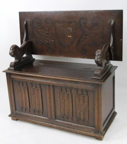 A 20thC Jacobean style oak finish monk's bench