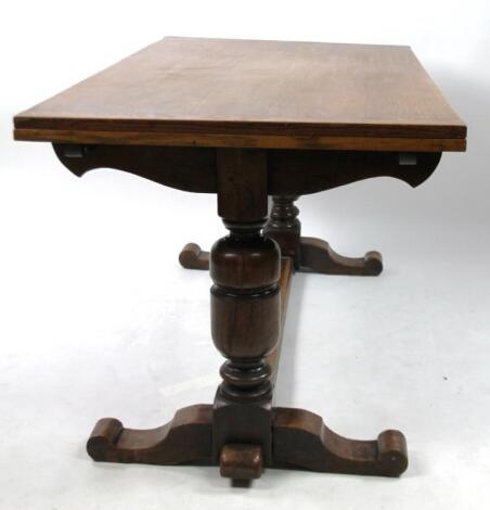 A early 20thC oak refectory style draw leaf dining table