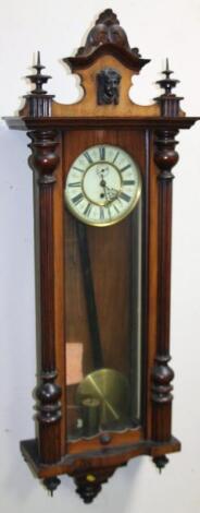 A late 19thC walnut cased single weight Vienna wall clock