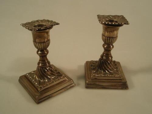 A pair of late Victorian silver boudoir candlesticks