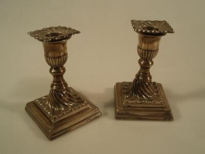 A pair of late Victorian silver boudoir candlesticks