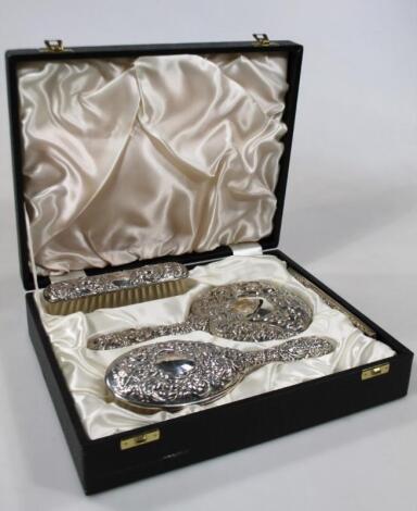 A boxed Elizabeth II silver three piece dressing table set