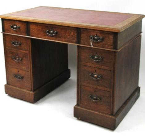 A late 19thC oak twin pedestal writing desk