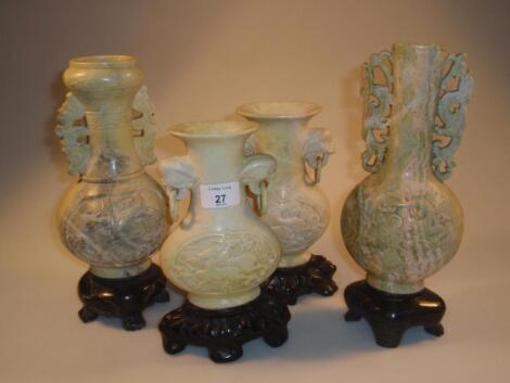 A pair of 19th century Chinese soapstone vases with integral stands and two similar vases