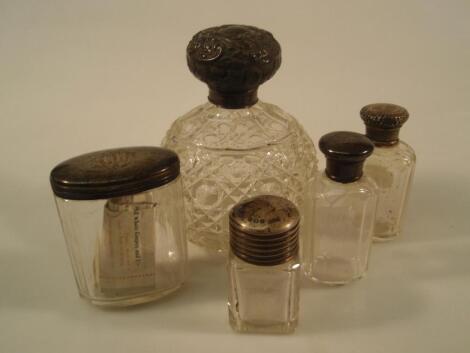 An Edward VII cut glass scent bottle with a silver cover