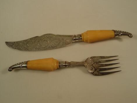 A pair of Victorian engraved EPNS cake servers with ivory and silver mounted handles