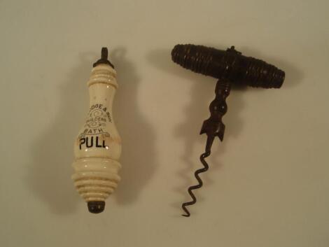 A 19thC corkscrew with a turned fruit wood handle (brush missing)