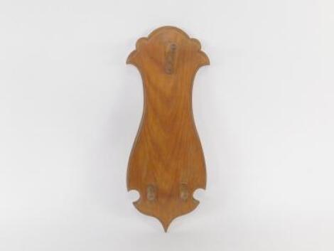 An oak shield backed wall hanging coat and hat stand