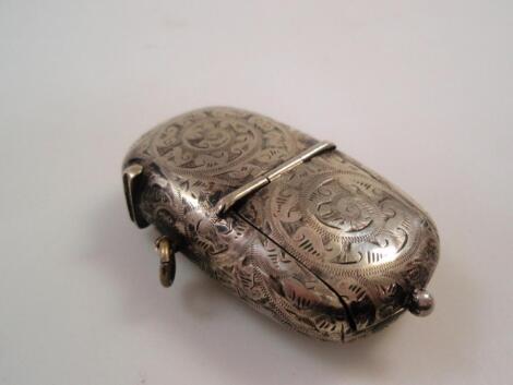 An early 20thC white metal vesta case and sovereign holder engraved with foliate scrolls