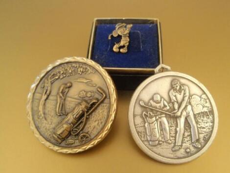 Two golfing medals and a Mickey Mouse golfing tie pin