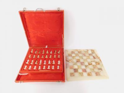 A late 20thC green and white onyx chess set and board