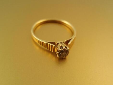 An 18ct dress ring, illusion set with a tiny diamond