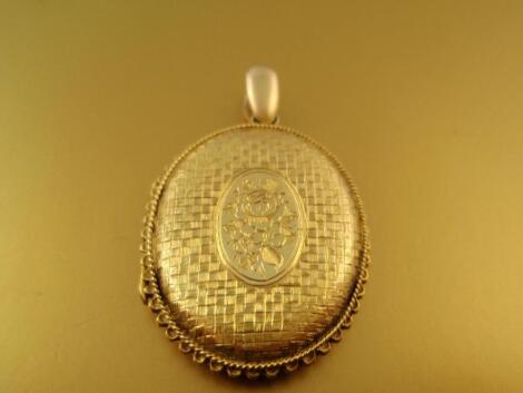 A yellow metal oval locket