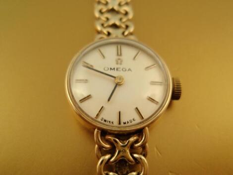 A ladies Omega 9ct gold round faced wrist watch