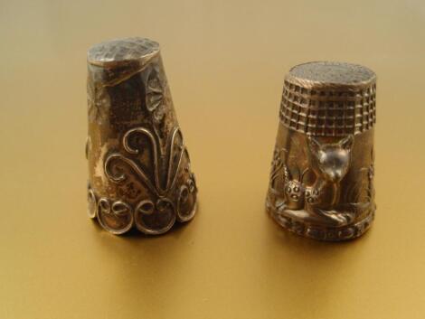 Two silver thimbles.