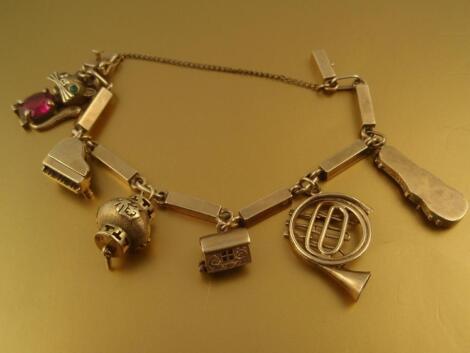 A bar linked charm bracelet stamped 9ct