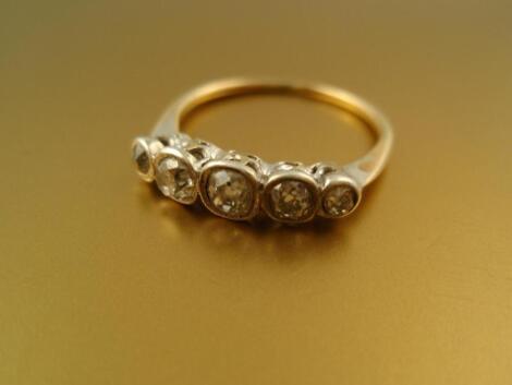 A five stone diamond set half hoop ring