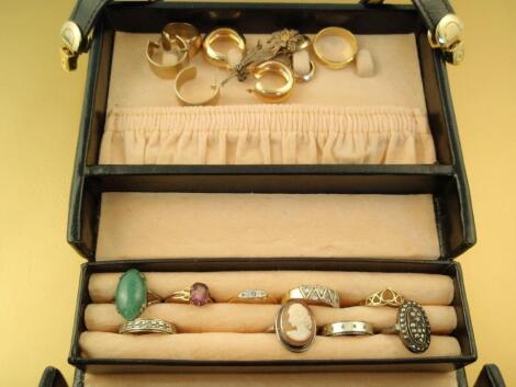 A small black travelling jewellery case and contents of dress rings