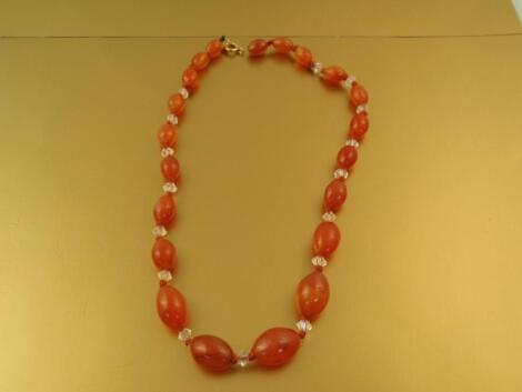 A string of graduated oval carnelian beads