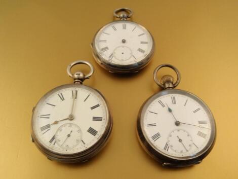 Three silver open faced pocket watches (one without hands)