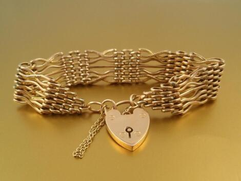 A 9ct gold fancy link gate bracelet with padlock clasp