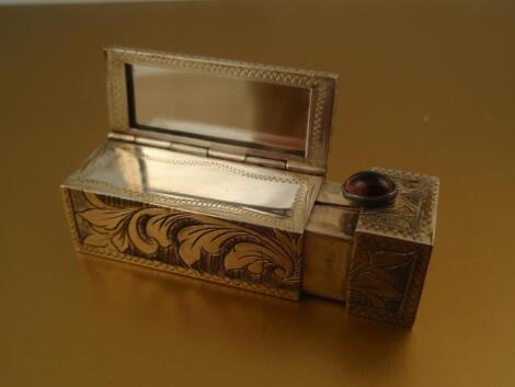 An Italian silver lipstick compact with integral mirror and cabachon button