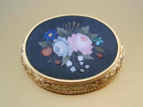 An oval micro mosaic brooch of 5cm x 4cm showing roses