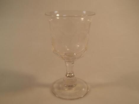 A 19thC wine goblet, the bell shape bowl etched with fruiting vine, facet