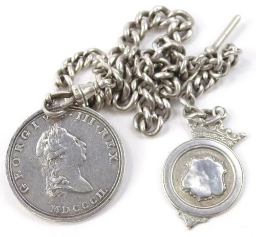 A silver watch chain and fob