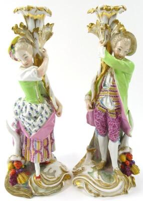 A pair of Continental figures of a lady and gentleman candle holders