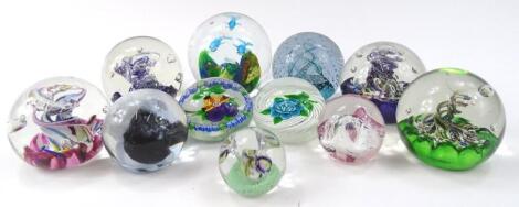 Various 20thC glass paperweights to include a swirl example set with blue and green flower