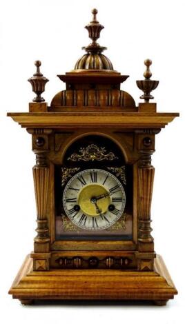 An Edwardian walnut mantel clock