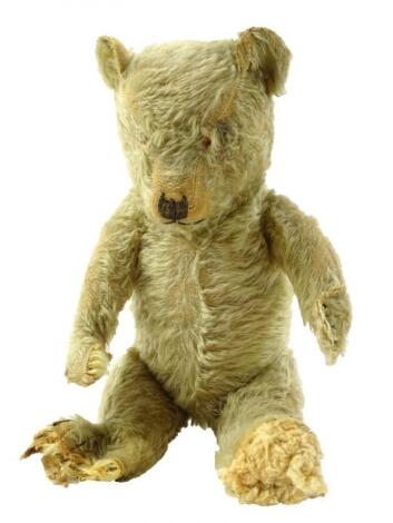 A mid 20thC blonde plush jointed teddy bear