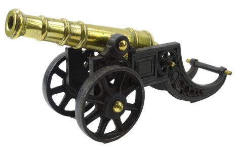 An early to mid 20thC cast iron and brass table cannon