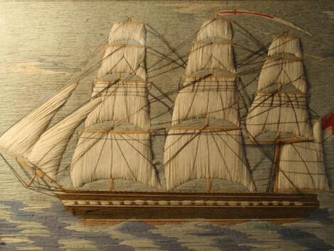 A Victorian sailor's woolwork picture of a three masted schooner in full sail