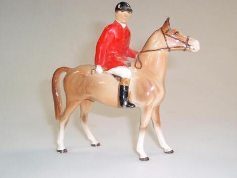 A Beswick style figure of a huntsman on horseback