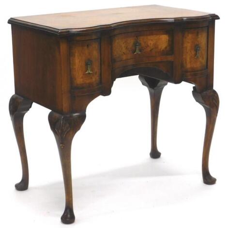 A walnut and burr walnut lowboy