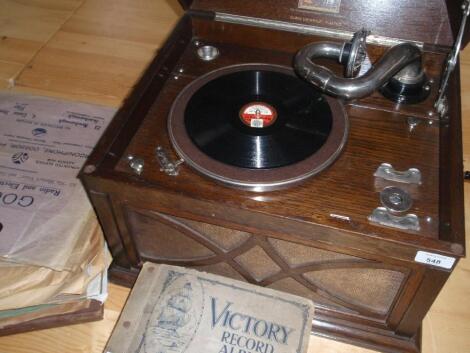 An oak-cased HMV cabinet gramophone and records